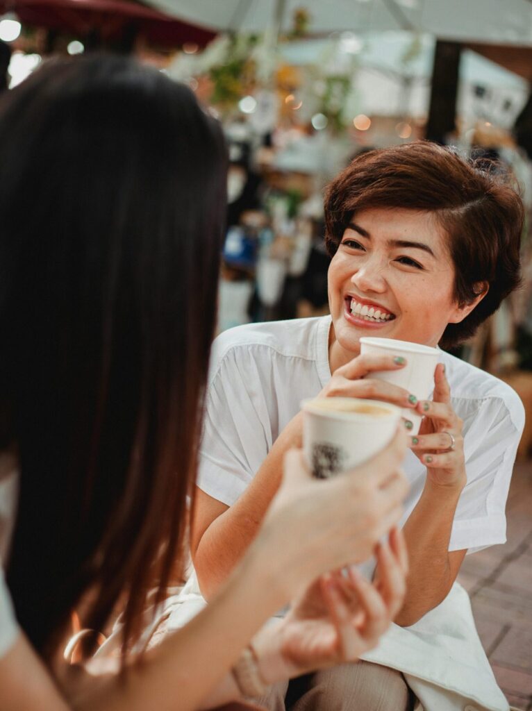 Two people talk over coffee