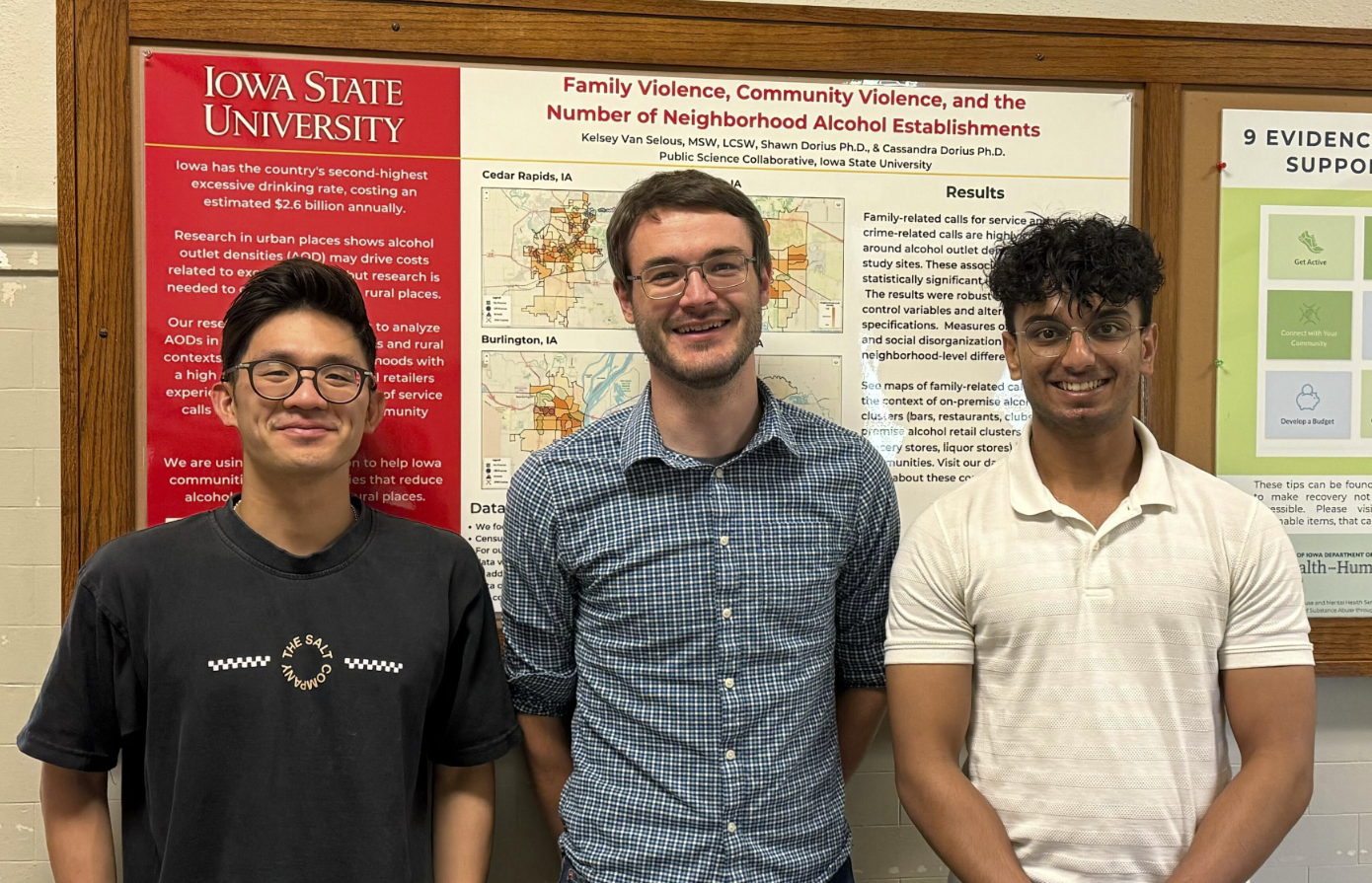 Alister, Matthew, and Dhairya stand in front of a PSC research poster