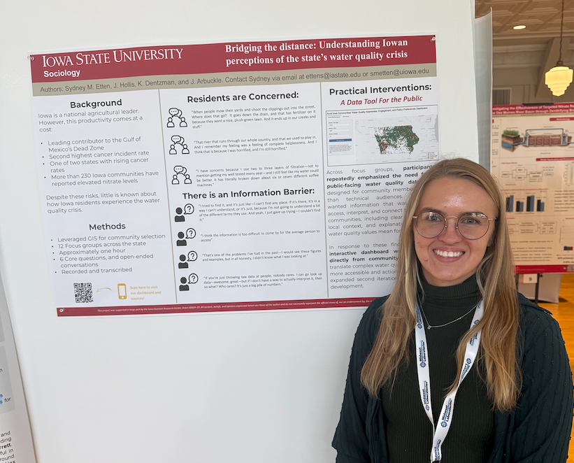 Sydney Etten stands in front of research poster at Iowa Water Conference